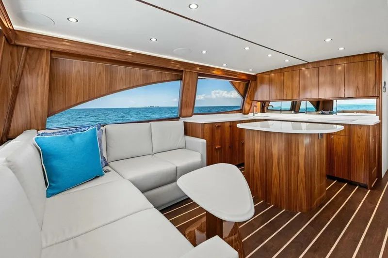 Galati Yacht Sales Trade Yacht Photos Pics Luxurious interior of 2025 Viking 58 Convertible yacht with elegant wood finishes and ocean view.