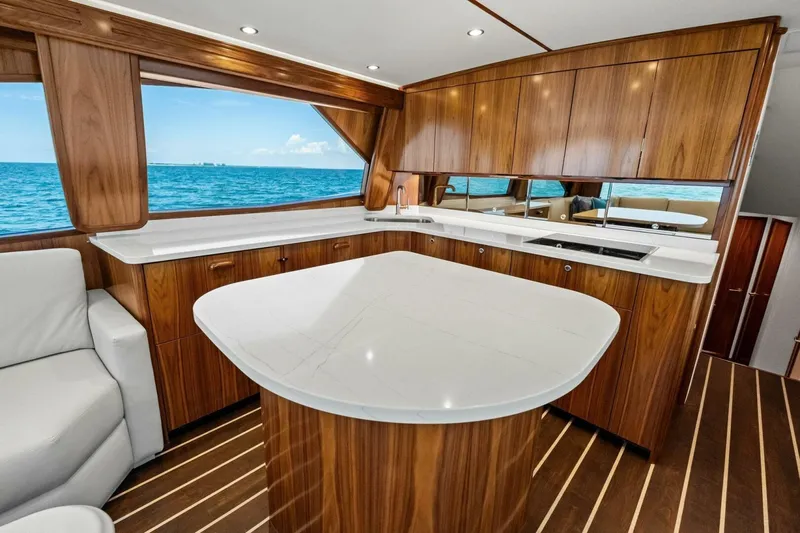 Galati Yacht Sales Trade Yacht Photos Pics Luxurious interior of 2025 Viking 58 Convertible yacht with elegant wood finishes.