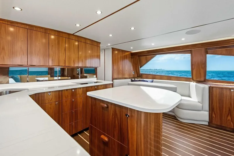 Galati Yacht Sales Trade Yacht Photos Pics Luxurious interior of 2025 Viking 58 Convertible yacht with elegant wood finishes and ocean view.