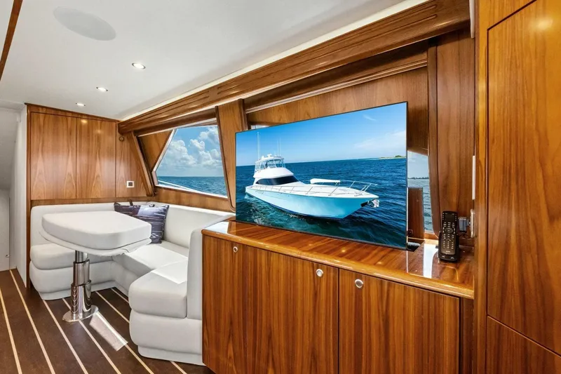 Galati Yacht Sales Trade Yacht Photos Pics Luxurious interior of 2025 Viking 58 Convertible yacht with wood paneling and modern amenities.
