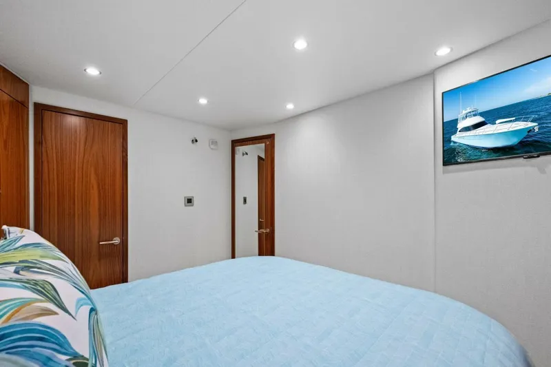 Galati Yacht Sales Trade Yacht Photos Pics Interior of 2025 Viking 58 Convertible yacht bedroom with modern decor and wall-mounted TV.