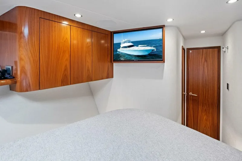 Galati Yacht Sales Trade Yacht Photos Pics Interior of 2025 Viking 58 Convertible yacht with wood cabinetry and wall-mounted TV.