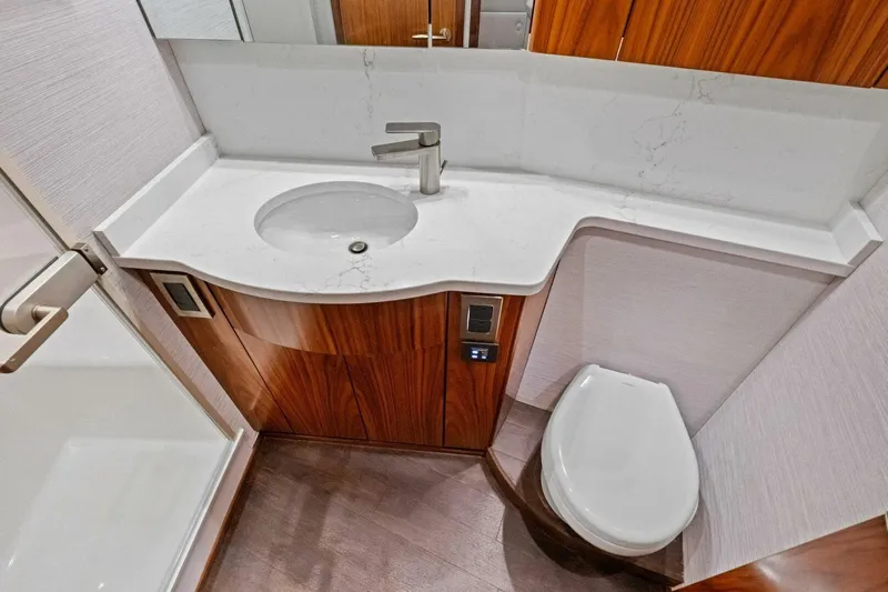 Galati Yacht Sales Trade Yacht Photos Pics Luxurious bathroom in 2025 Viking 58 Convertible yacht with modern fixtures and wood accents.