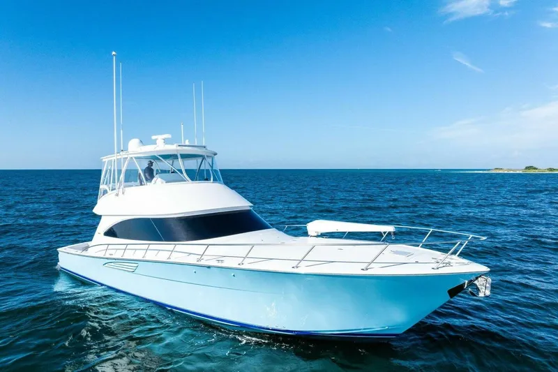 Galati Yacht Sales Trade Yacht Photos Pics 2025 Viking 58 Convertible yacht cruising on open blue sea under clear sky.