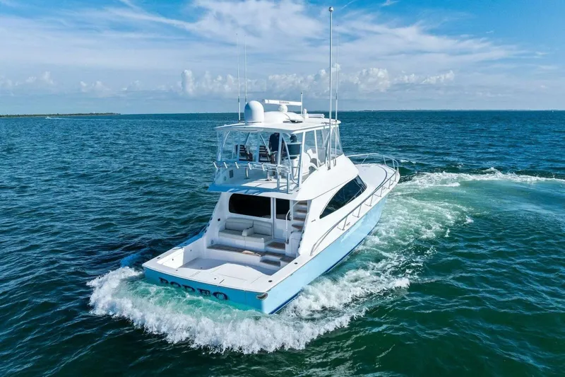 Galati Yacht Sales Trade Yacht Photos Pics 2025 Viking 58 Convertible yacht cruising on open ocean under clear blue sky.