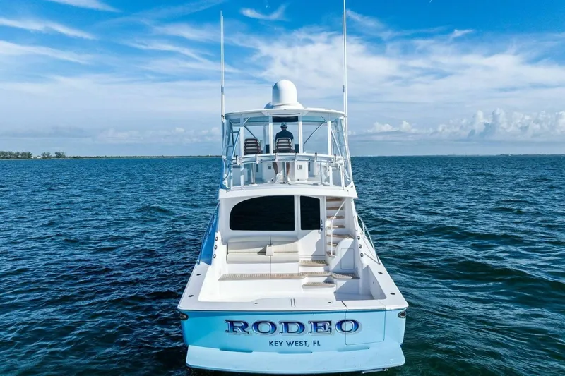 Galati Yacht Sales Trade Yacht Photos Pics 2025 Viking 58 Convertible yacht on open ocean, clear skies, "Rodeo" name visible.