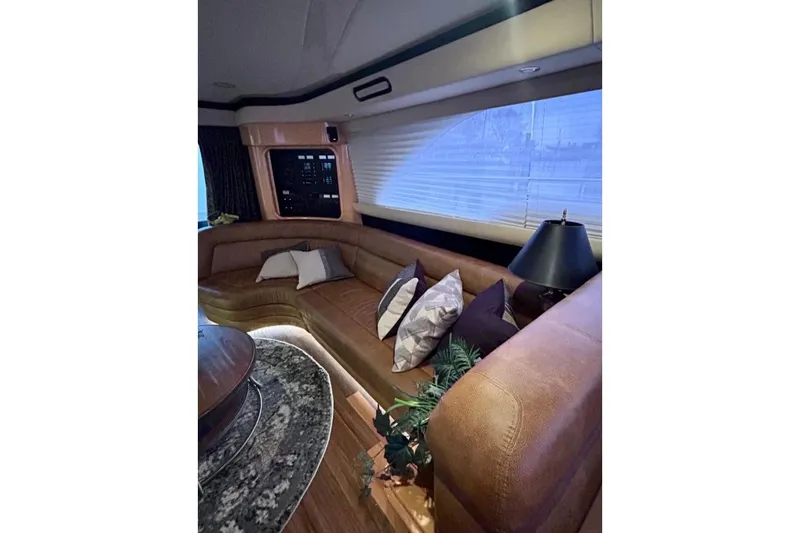  Yacht Photos Pics Luxurious interior of 2001 Sea Ray 560 Sedan Bridge with plush seating and elegant decor.