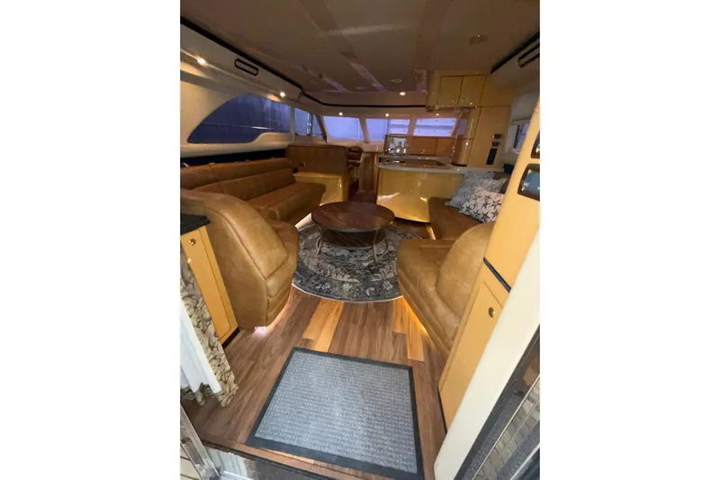  Yacht Photos Pics Luxurious interior of 2001 Sea Ray 560 Sedan Bridge yacht with leather seating and wooden flooring.