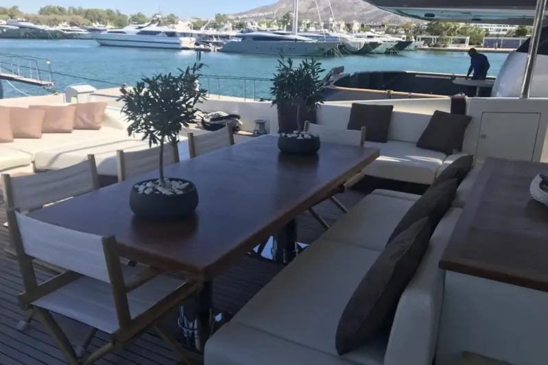  Yacht Photos Pics Luxurious 2010 Azimut 103S yacht deck with elegant seating and dining area.