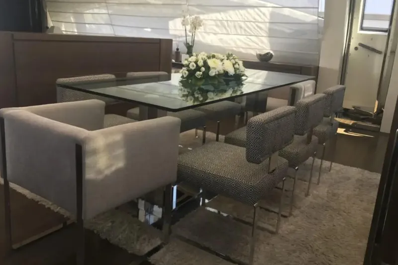  Yacht Photos Pics Luxurious dining area on 2010 Azimut 103S yacht with glass table and elegant chairs.