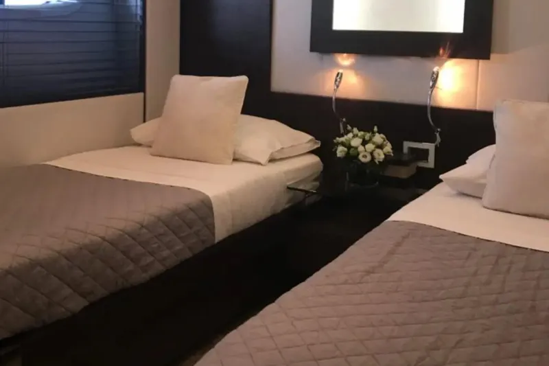  Yacht Photos Pics Luxurious twin bedroom on 2010 Azimut 103S yacht with elegant decor and soft lighting.