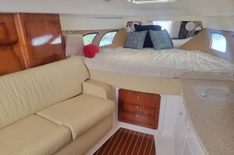  Yacht Photos Pics Interior of 2010 Intrepid 39 Kevlar Hull yacht with cozy bed and seating area.