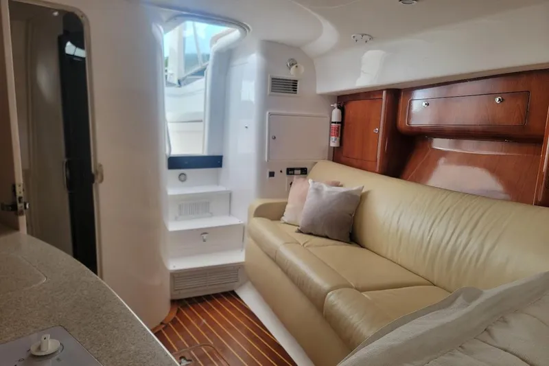  Yacht Photos Pics Interior of 2010 Intrepid 39 Kevlar Hull yacht with beige leather seating and wooden accents.