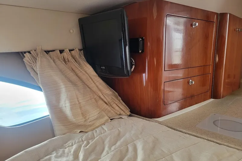  Yacht Photos Pics Interior of 2010 Intrepid 39 Kevlar Hull yacht with TV and wooden cabinetry.