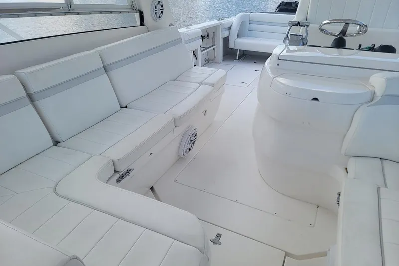  Yacht Photos Pics Luxurious white interior of 2010 Intrepid 39 Kevlar Hull sport yacht, featuring spacious seating.