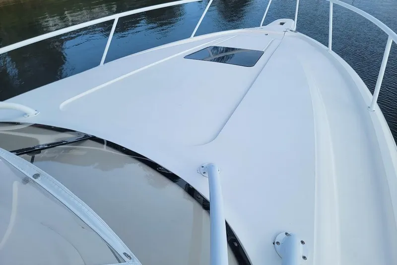  Yacht Photos Pics 2010 Intrepid 39 Kevlar Hull yacht deck, sleek design, white finish, calm water backdrop.