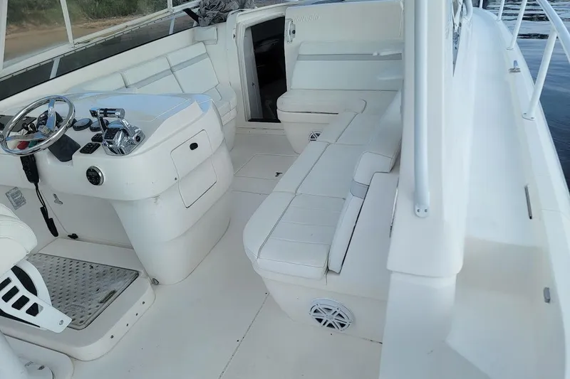  Yacht Photos Pics Interior of 2010 Intrepid 39 Kevlar Hull Sport Yacht, featuring white seating and helm.