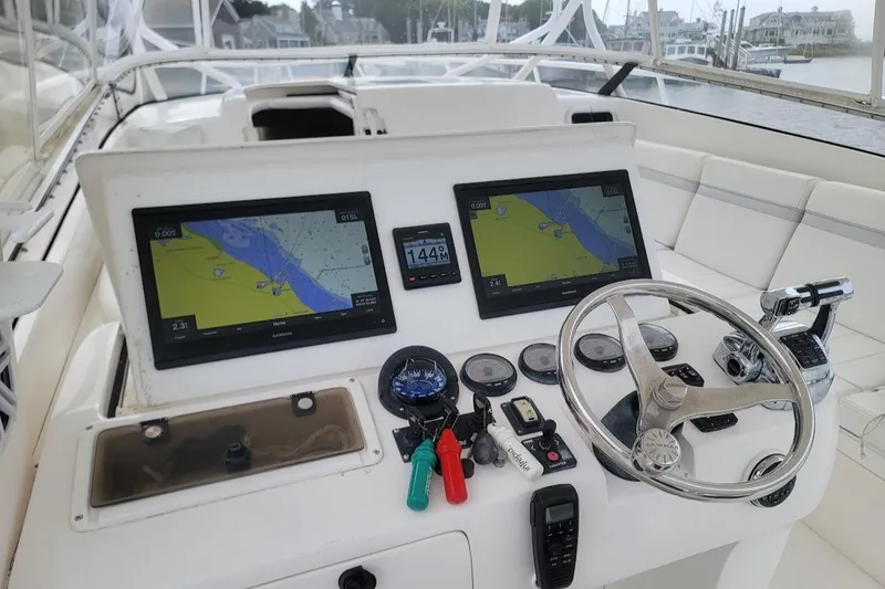  Yacht Photos Pics 2010 Intrepid 39 Kevlar Hull yacht cockpit with navigation screens and steering wheel.
