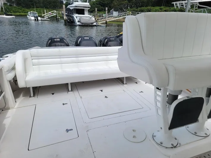  Yacht Photos Pics 2010 Intrepid 39 Kevlar Hull yacht interior with white seating and multiple outboard motors.