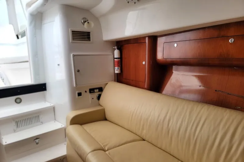  Yacht Photos Pics Interior of 2010 Intrepid 39 Kevlar Hull yacht with beige seating and wooden cabinetry.