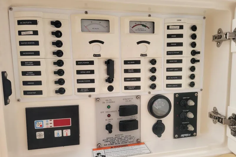  Yacht Photos Pics Control panel of a 2010 Intrepid 39 Kevlar Hull Sport Yacht, featuring various switches and gauges.