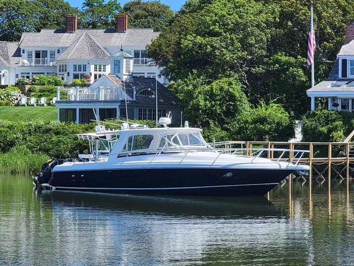  Yacht Photos Pics 2010 Intrepid 39 Kevlar Hull yacht docked by waterfront homes.