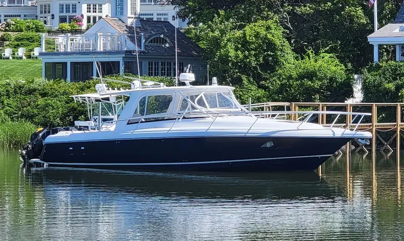  Yacht Photos Pics 2010 Intrepid 39 Kevlar Hull Sport Yacht docked by waterfront homes.