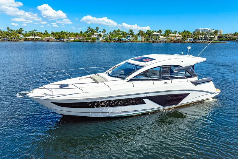  Yacht Photos Pics 2024 Beneteau Gran Turismo 45 yacht cruising on a sunny day, surrounded by calm waters.