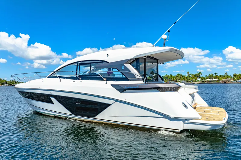  Yacht Photos Pics 2024 Beneteau Gran Turismo 45 yacht on water under clear blue sky.