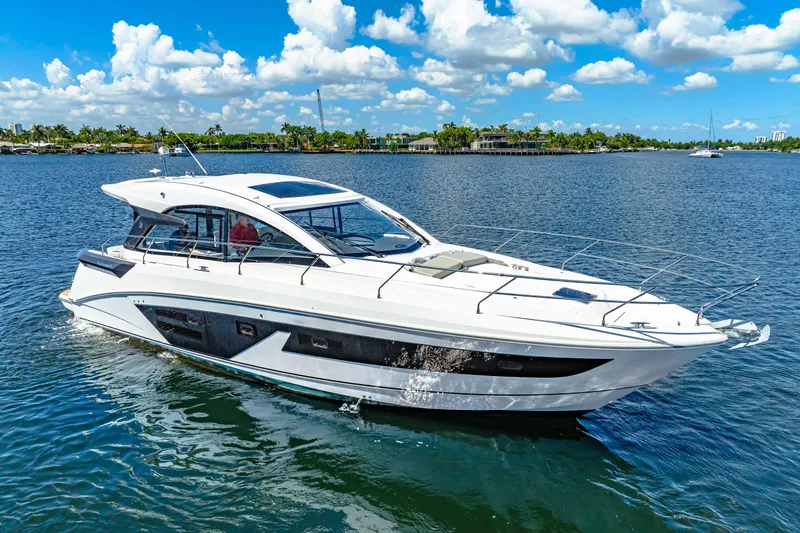  Yacht Photos Pics 2024 Beneteau Gran Turismo 45 yacht cruising on a sunny day, blue sky and water.