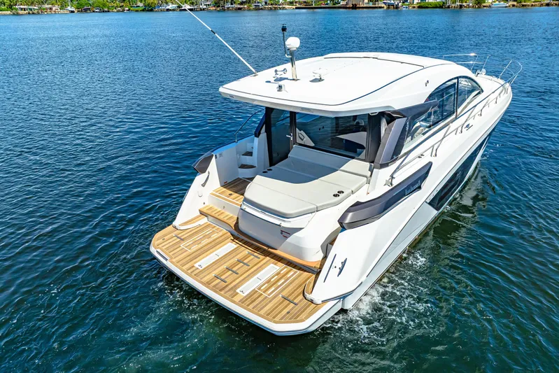  Yacht Photos Pics 2024 Beneteau Gran Turismo 45 yacht cruising on a serene blue lake.