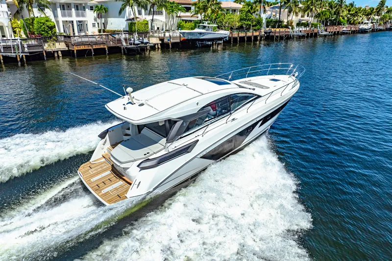  Yacht Photos Pics 2024 Beneteau Gran Turismo 45 yacht cruising on a scenic waterway.