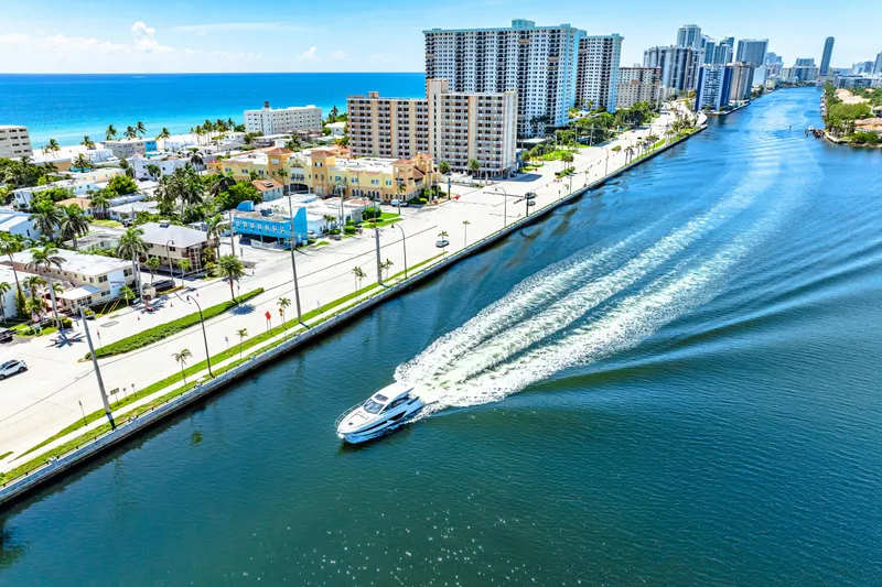  Yacht Photos Pics 2024 Beneteau Gran Turismo 45 cruising along a scenic coastal waterway.