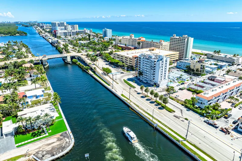  Yacht Photos Pics Aerial view of 2024 Beneteau Gran Turismo 45 cruising through a coastal city canal.