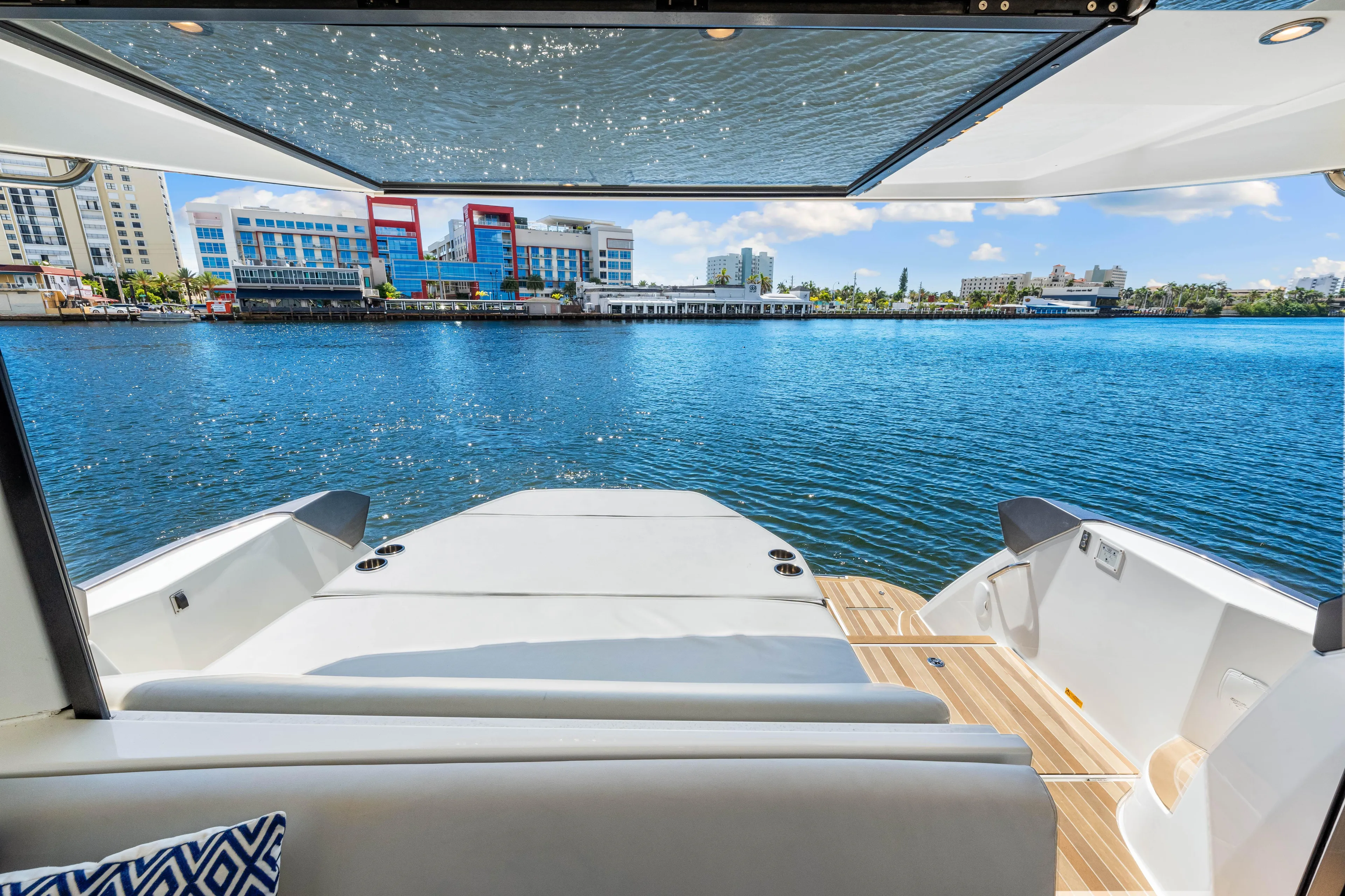  Yacht Photos Pics 2024 Beneteau Gran Turismo 45 yacht with waterfront city view, featuring spacious deck.