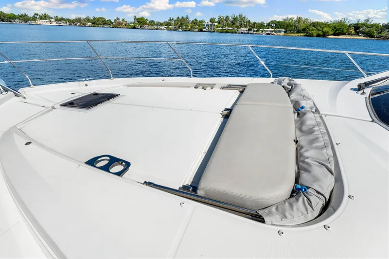  Yacht Photos Pics 2024 Beneteau Gran Turismo 45 yacht deck with seating, overlooking serene water and lush shoreline.