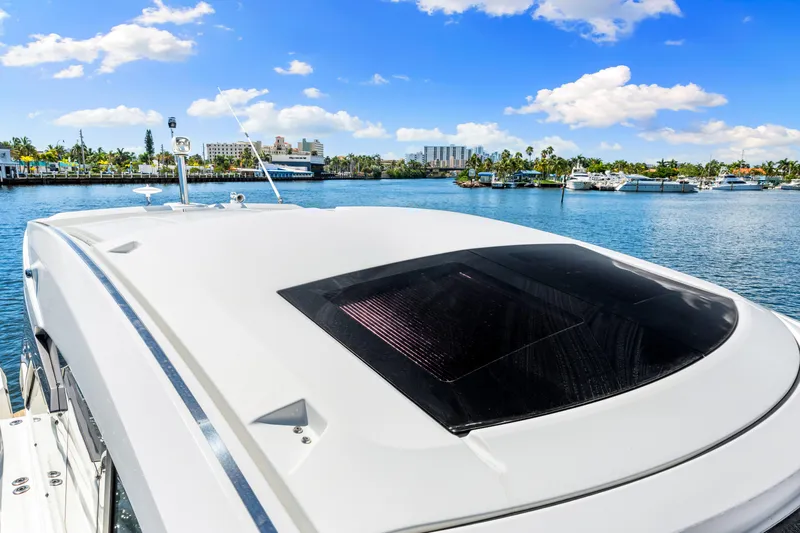  Yacht Photos Pics 2024 Beneteau Gran Turismo 45 yacht on serene water with clear blue sky.