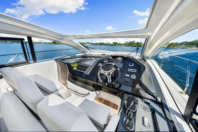  Yacht Photos Pics Luxurious helm of 2024 Beneteau Gran Turismo 45 yacht with panoramic water views.