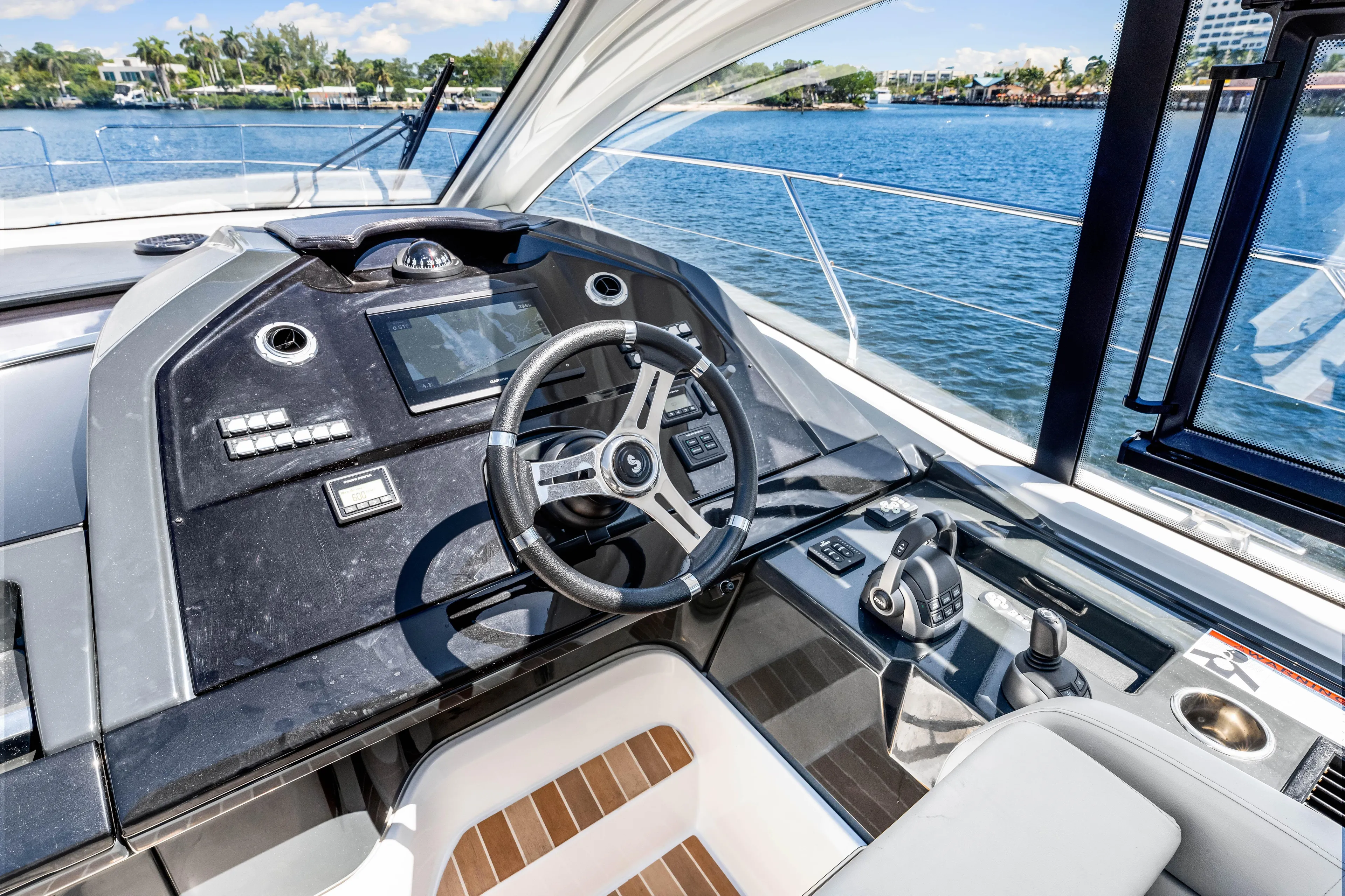  Yacht Photos Pics 2024 Beneteau Gran Turismo 45 helm with modern controls and scenic water view.