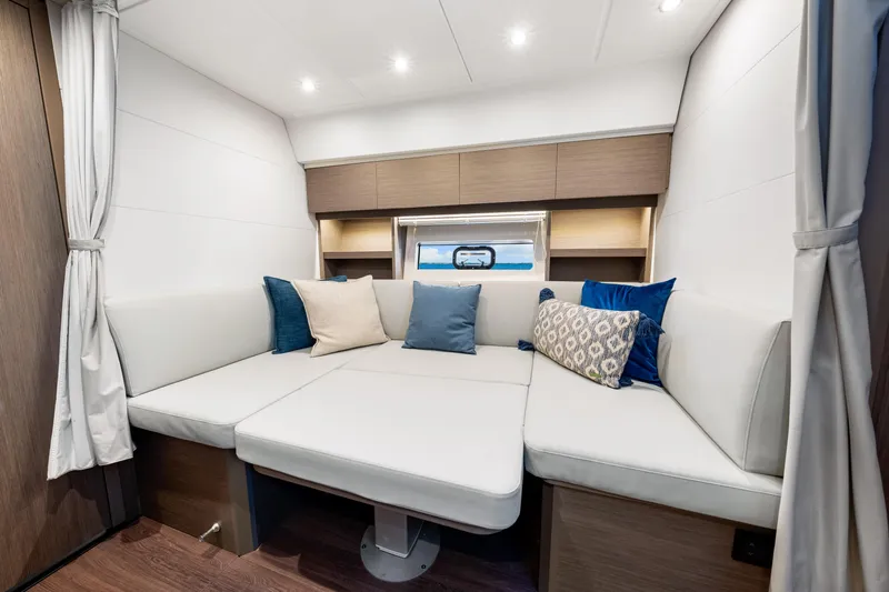  Yacht Photos Pics Luxurious interior of 2024 Beneteau Gran Turismo 45 yacht with plush seating and cushions.