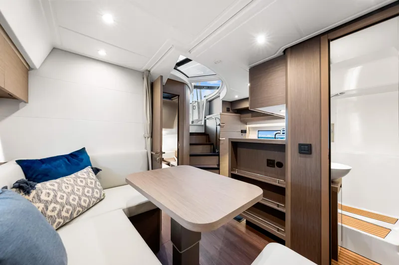  Yacht Photos Pics Luxurious interior of 2024 Beneteau Gran Turismo 45 yacht, featuring modern seating and elegant wood finishes.