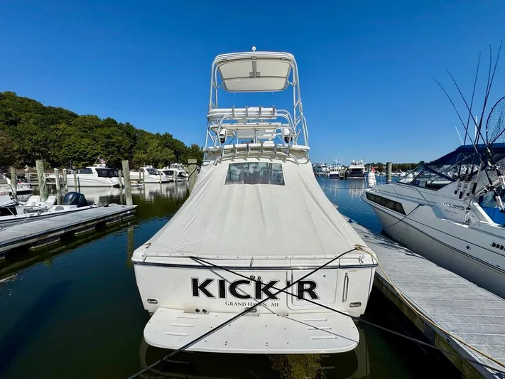  Yacht Photos Pics 2006 Rampage 33 Express boat docked at marina, covered and secured.