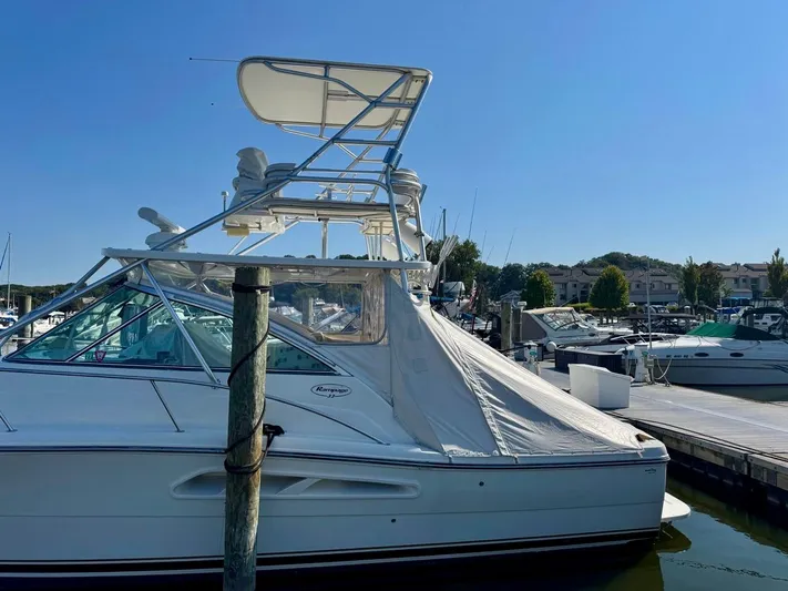  Yacht Photos Pics 2006 Rampage 33 Express boat docked at marina under clear blue sky.