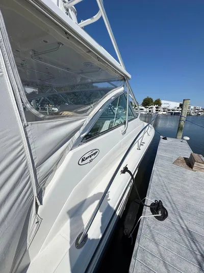  Yacht Photos Pics 2006 Rampage 33 Express boat docked at marina under clear blue sky.
