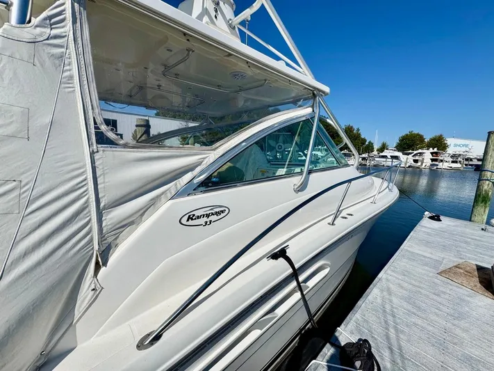  Yacht Photos Pics 2006 Rampage 33 Express boat docked at marina under clear blue sky.