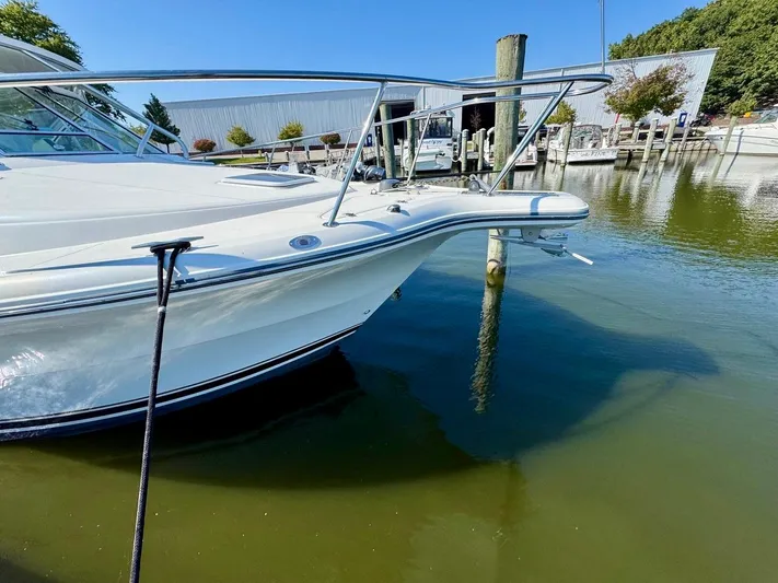  Yacht Photos Pics 2006 Rampage 33 Express boat docked in a marina, clear blue sky.
