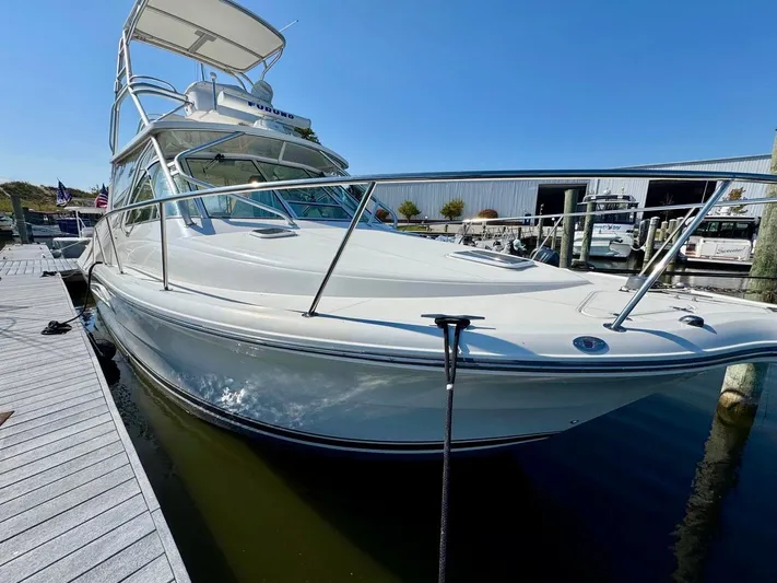  Yacht Photos Pics 2006 Rampage 33 Express boat docked at marina under clear blue sky.