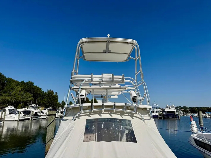  Yacht Photos Pics 2006 Rampage 33 Express boat docked in a marina under clear blue skies.