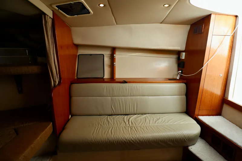  Yacht Photos Pics Interior of 2006 Rampage 33 Express yacht with beige leather seating and wooden accents.