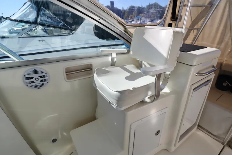  Yacht Photos Pics 2006 Rampage 33 Express boat interior with white captain's chair and speaker.